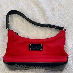 Kate Spade Small Handbag. Gently used. Red with Navy Handles.
